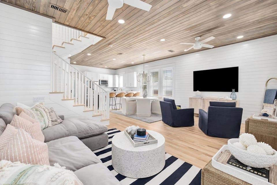 Bright living room w/ cozy seating, wood ceilings, and an open layout made for relaxing together
