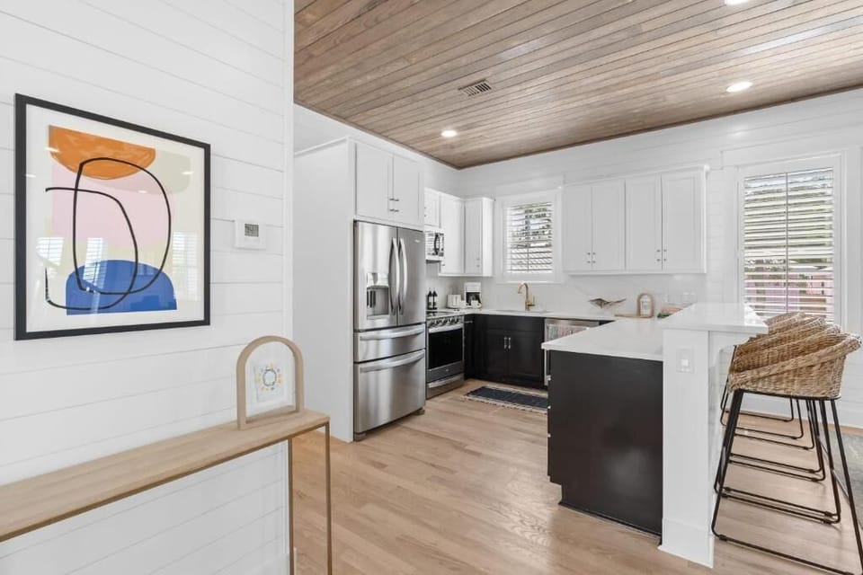 Modern kitchen w/ clean lines, open shelving & warm wood floors