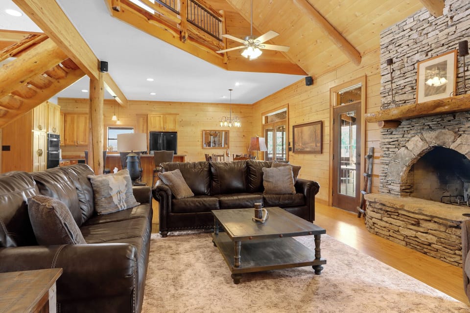 The living room features a full size sofa sleeper.  Beyond it is the kitchen and dining area.