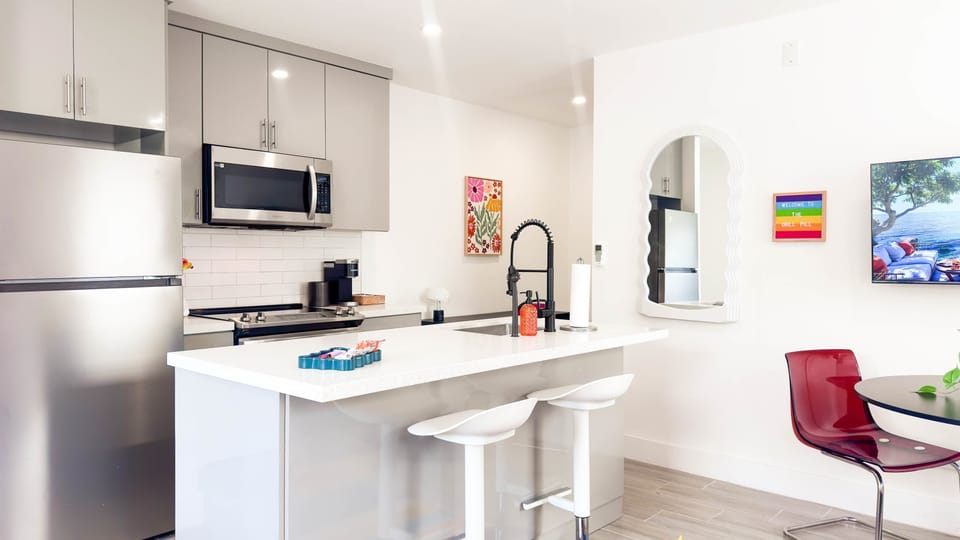 Barstool seating at the kitchen counter makes it easy to eat, drink, and hang out together.