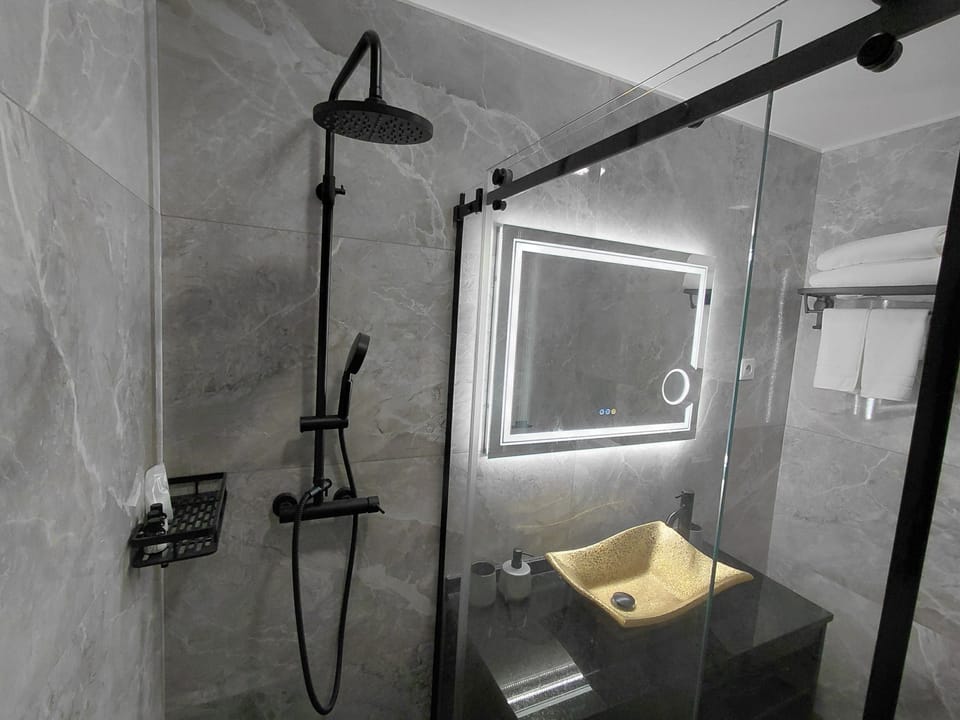 Shower, rainfall showerhead, hair dryer, towels