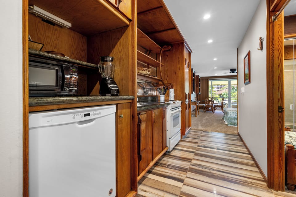 Your fully-equipped kitchen awaits with everything you need to prepare meals during your stay, from modern appliances to thoughtful details, all set in warm wood cabinetry.