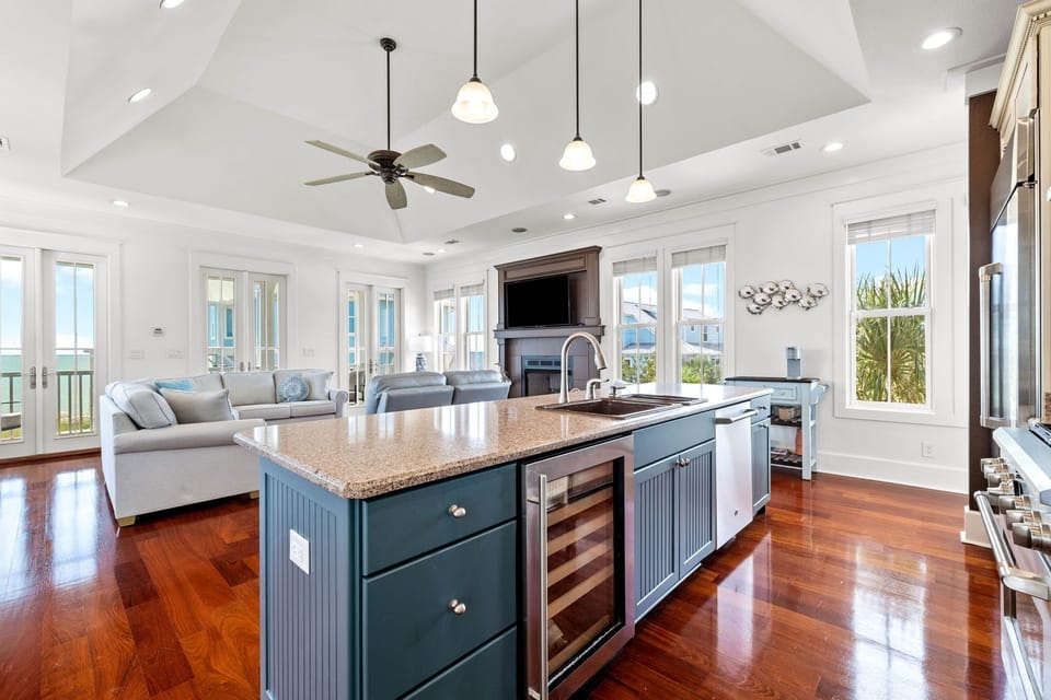 Your spacious open-concept kitchen flows seamlessly into the living area, featuring gleaming hardwood floors and stunning ocean views through every window.