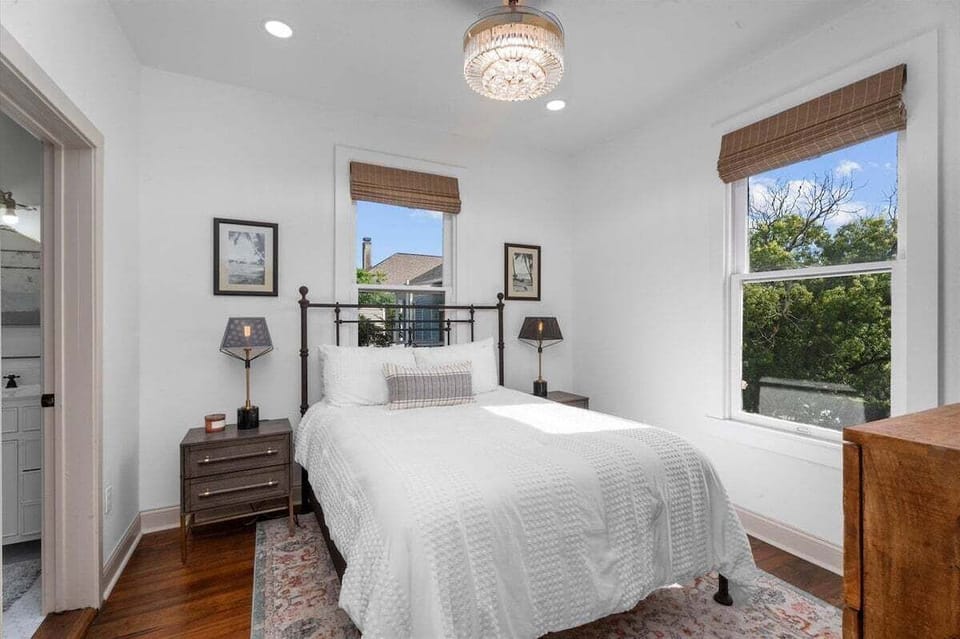 Bright bedroom with comfortable bed and large windows