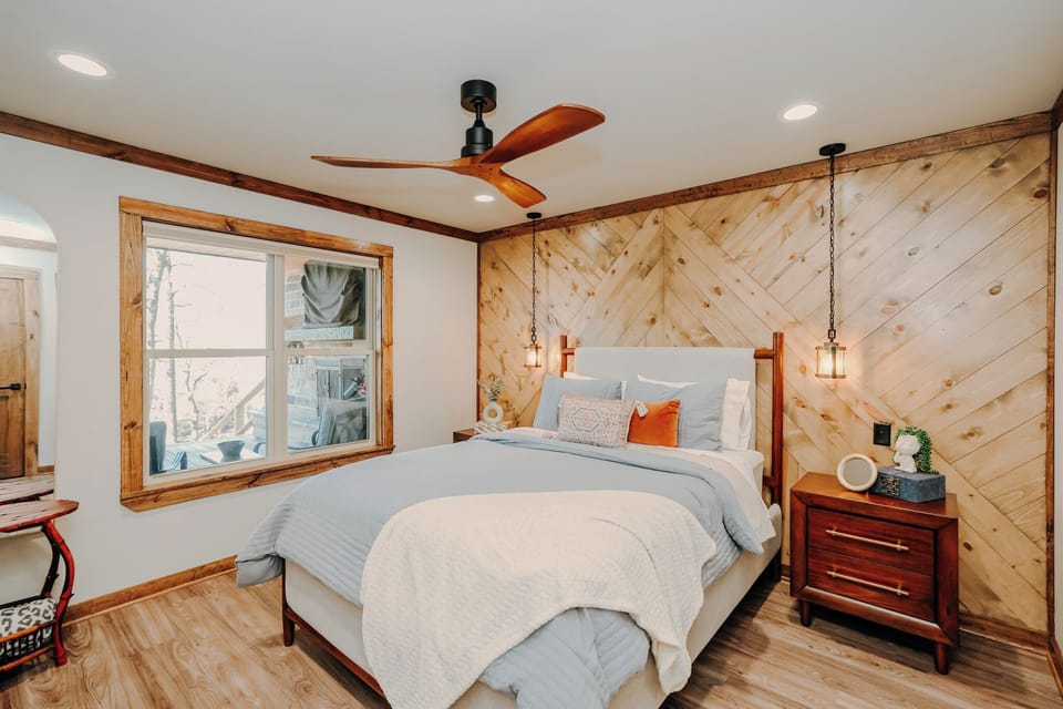 Primary Bedroom with warm wood accents and peaceful river views.