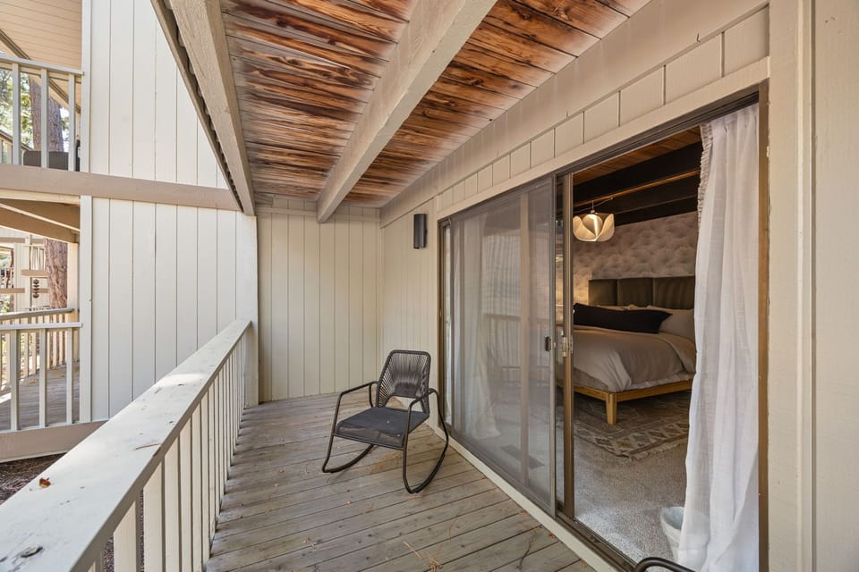 Balcony located off Bedroom #1 with an outdoor rocking chair