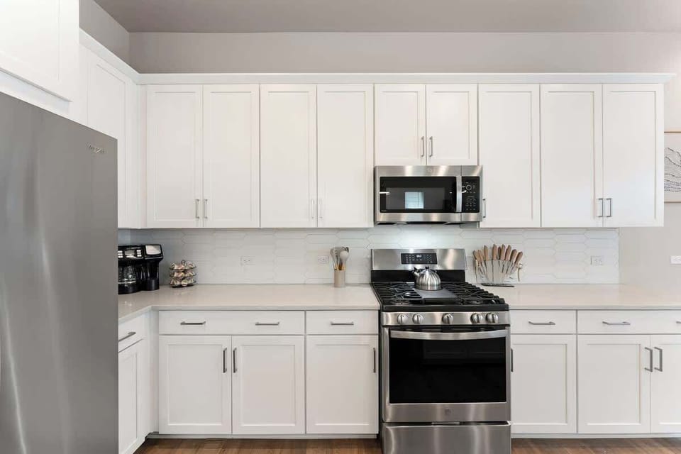 Modern, bright kitchen with stainless steel appliances, spacious countertops, and ample storage. Ideal for cooking during long stays. Your home away from home!