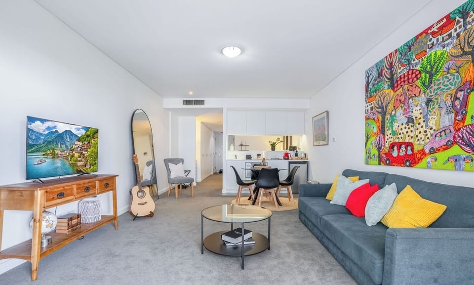 A bright and vibrant living space adorned with colorful wall art and comfortable seating.