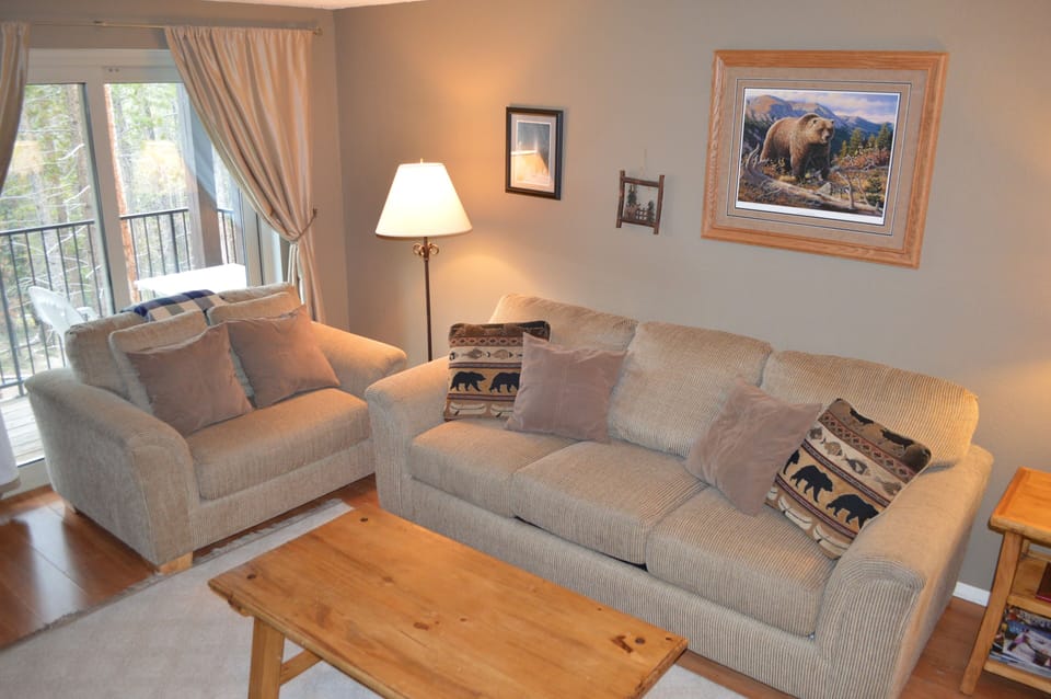 Sink into plush sofas with wildlife-themed pillows while natural light streams through your private balcony doors.
