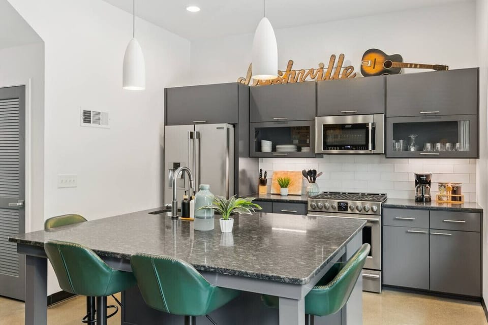 Updated, fully-equipped kitchen with high-end appliances and seating for four at the counter.