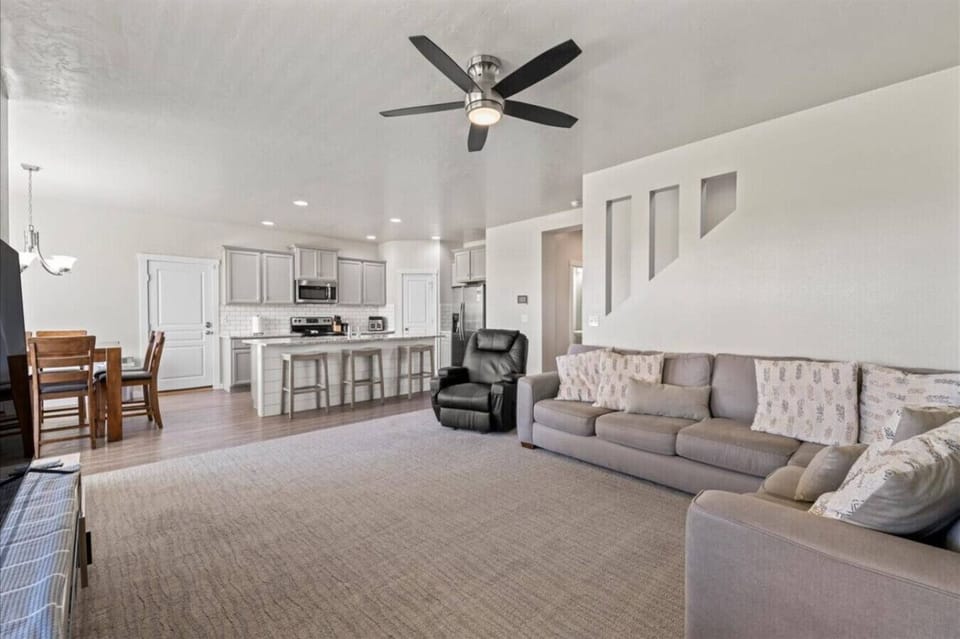 Spacious open-concept living area with direct flow to the kitchen and dining space. Comfortable seating and a functional layout make it ideal for groups or families.