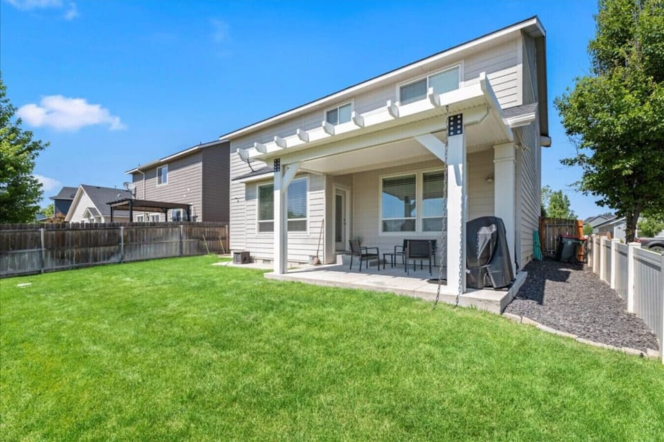 Spacious backyard with added privacy and no homes behind. Covered patio seating plus BBQ and smoker for outdoor meals.