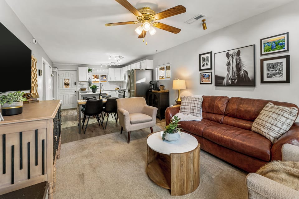 - Enjoy a welcoming open plan layout with warm lighting and cozy textures throughout
- Leather couch, plush armchair, and wood accents create an inviting mountain vibe
- Easily transition from lounging to dining or prepping in the kitchen

