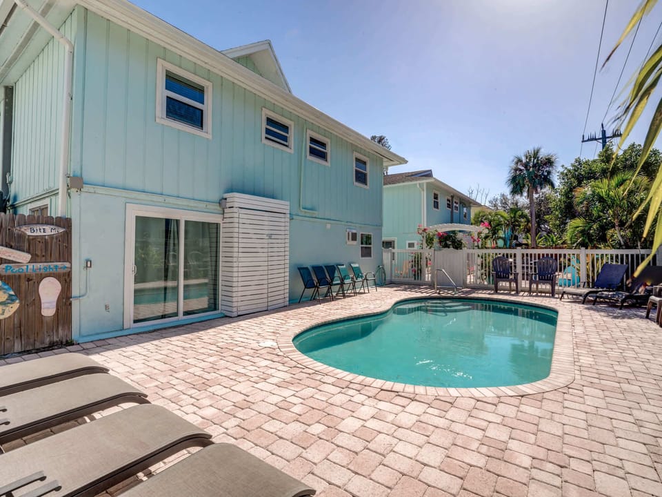 Heated Outdoor Pool with Ample Seating and Loungers