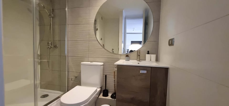 Sleek and modern bathroom with a spacious shower and stylish vanity, perfect for a refreshing start to your day.