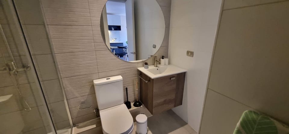 Modern bathroom with sleek fixtures and a spacious shower, perfect for a refreshing start to your day.