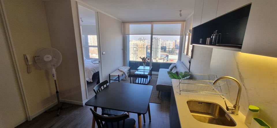 Enjoy stunning city views from this modern studio apartment, complete with a cozy living area and sleek kitchen.