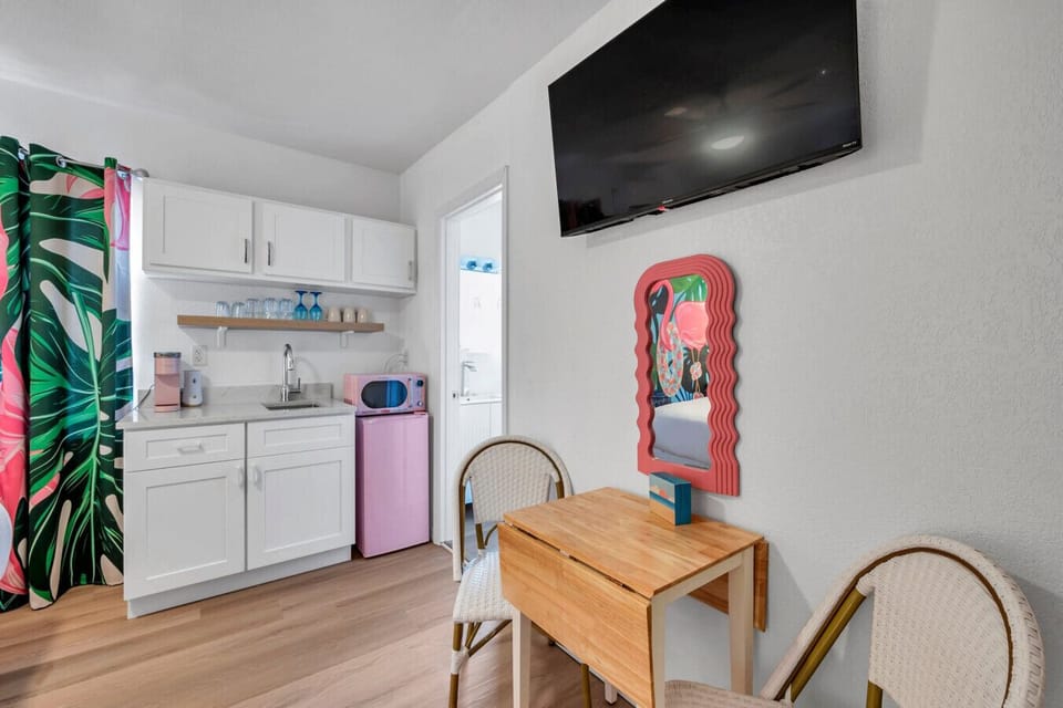Bright kitchenette w/ compact appliances & cheerful decor for easy snacks & drinks.