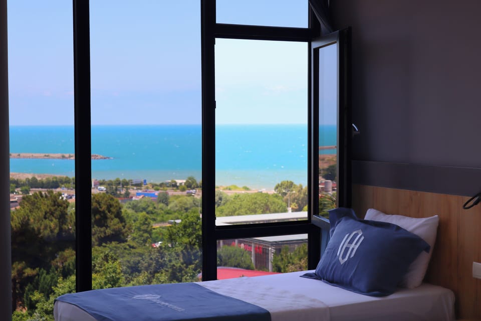 Deluxe Triple Room, Sea View | Desk, laptop workspace, soundproofing, iron/ironing board