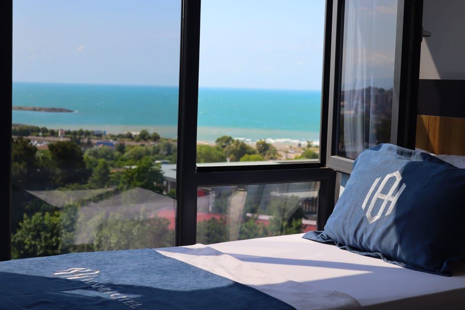 Deluxe Triple Room, Sea View | Desk, laptop workspace, soundproofing, iron/ironing board