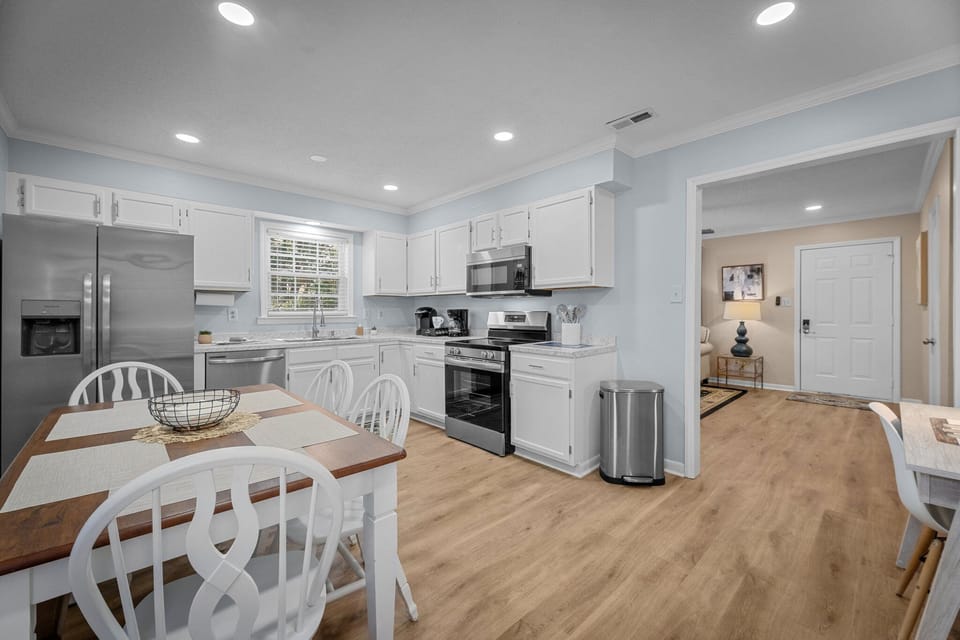 Kitchen with stainless appliances & table for 6—great for meals or entertaining.