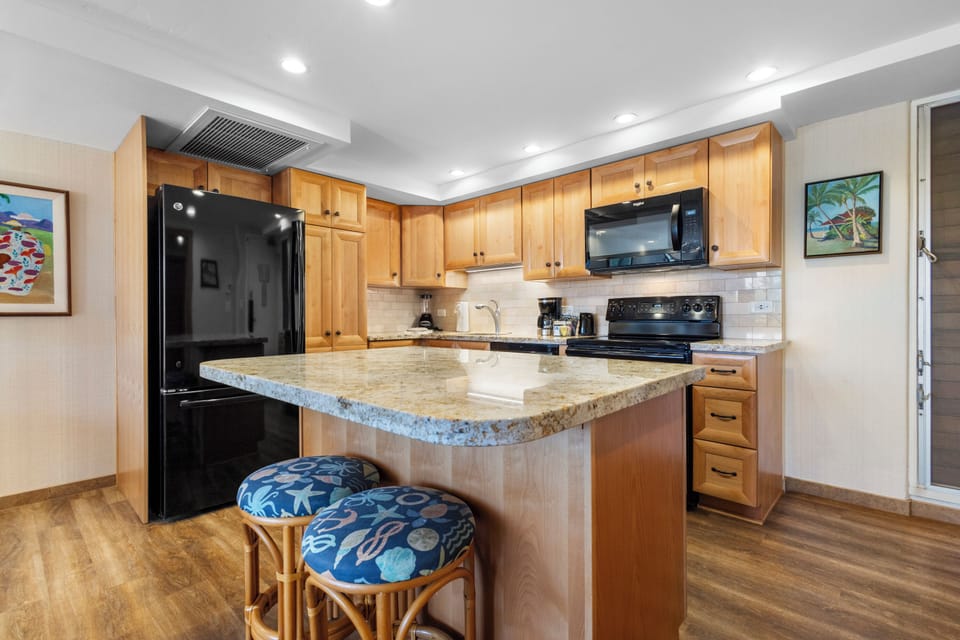 Your fully equipped kitchen awaits with granite counters, modern appliances, and a cozy breakfast bar—perfect for preparing meals or sipping morning coffee together.