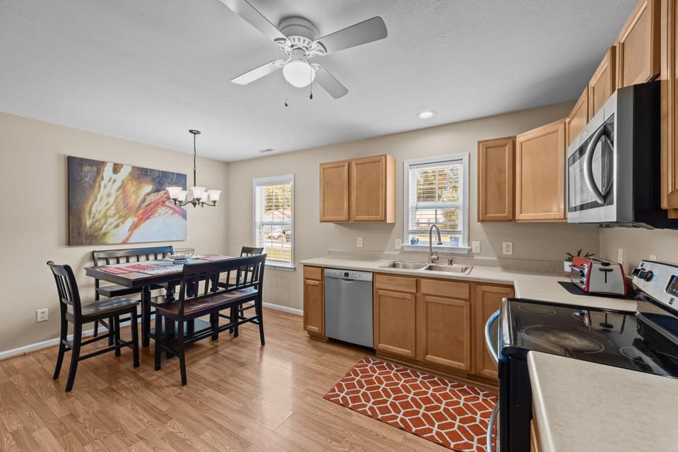 Kitchen with dishwasher and refrigerator that dispenses filtered water and ice.