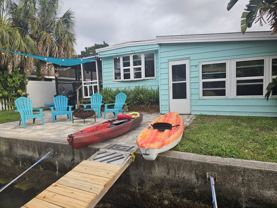 Firepit, Grill, and kayaks can all be found in the backyard.