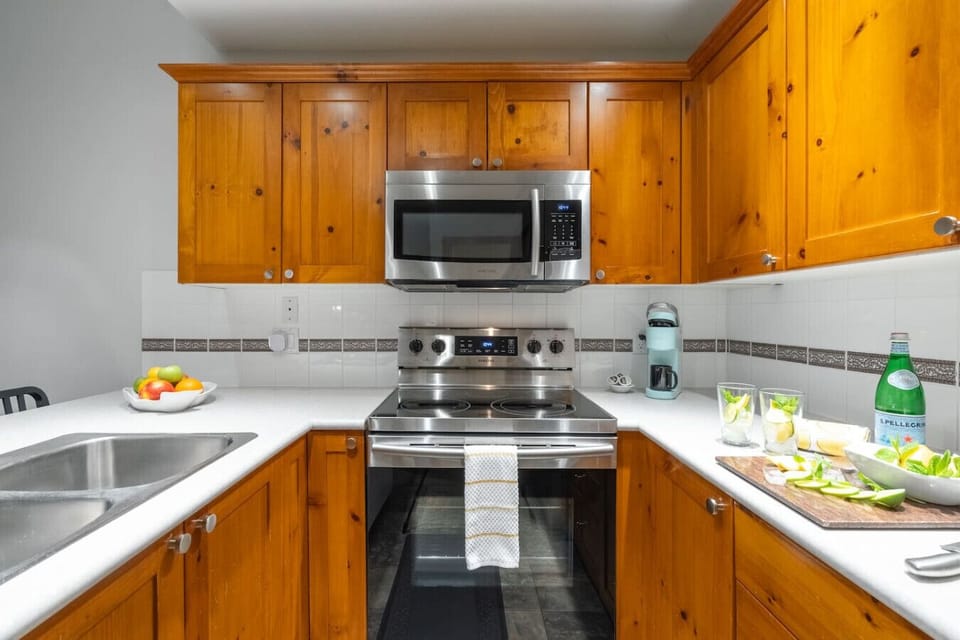 Kitchen fully equipped with oven, microwave and coffee maker for easy meal prep.