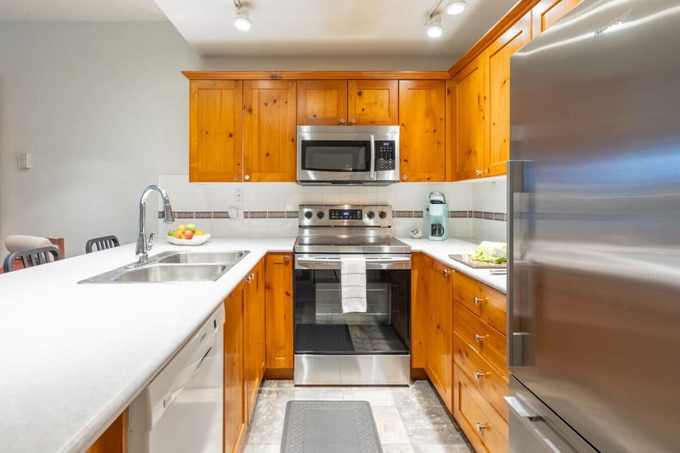 Cook in a spacious kitchen with dishwasher, large fridge and ample counter space.