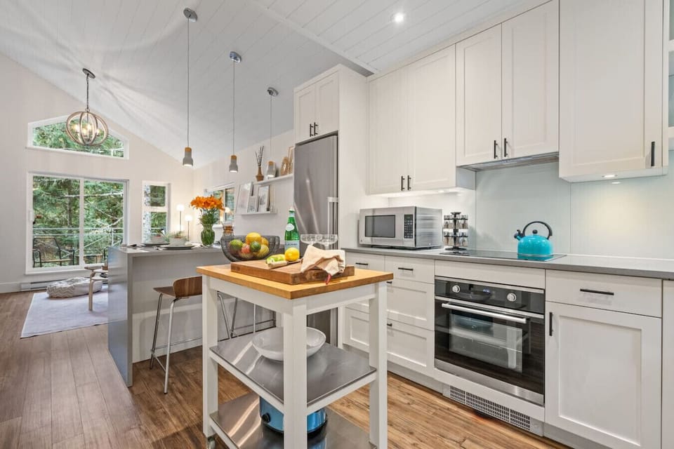 Fully stocked kitchen with high-quality stainless steel appliances for easy cooking.