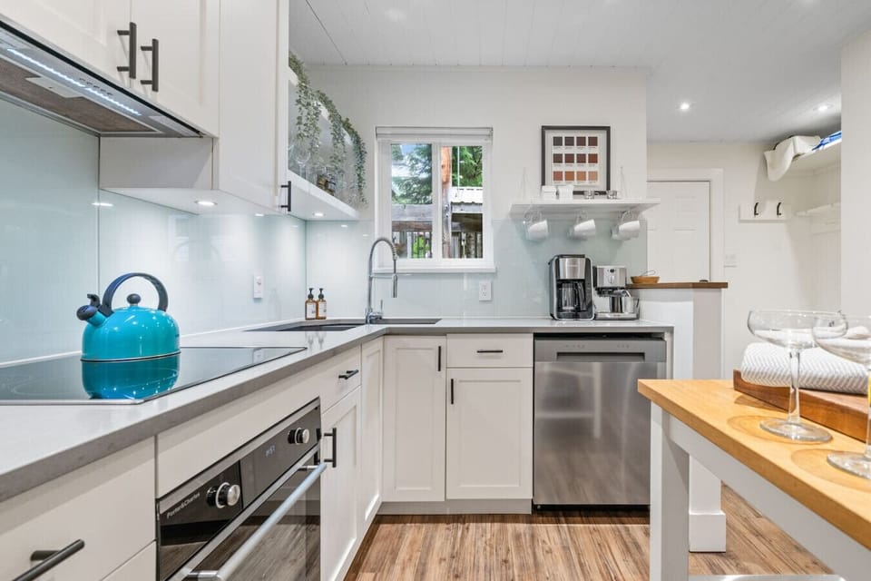 Kitchen stocked with premium teas, ground coffee, coffee maker and espresso.