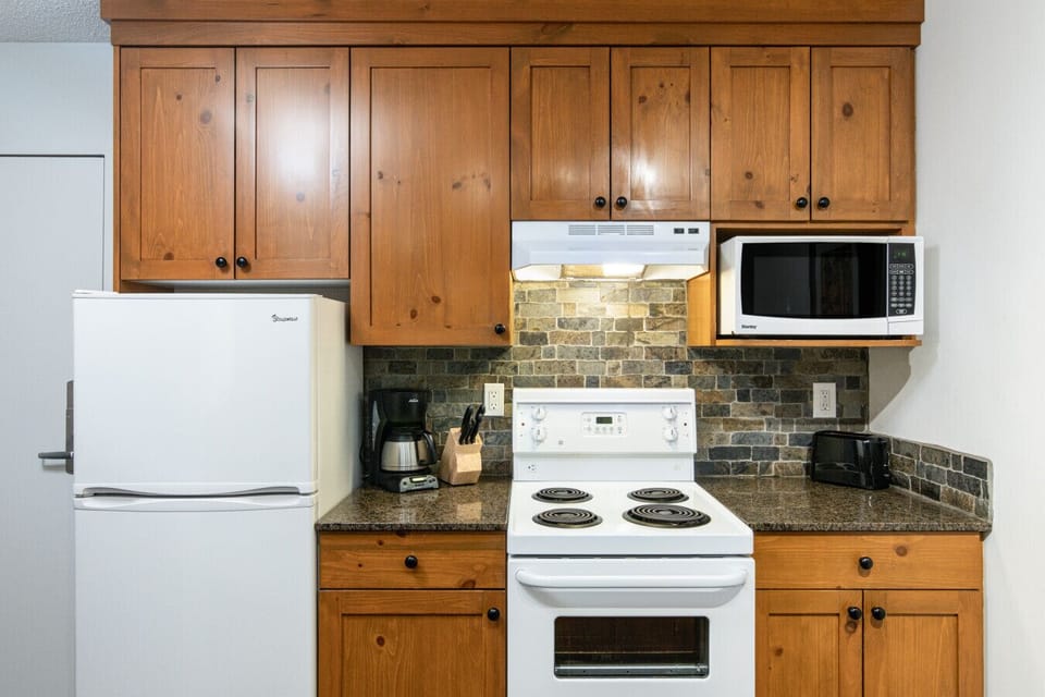 Kitchen with stove, oven, microwave, fridge, freezer, and coffee maker for easy meals