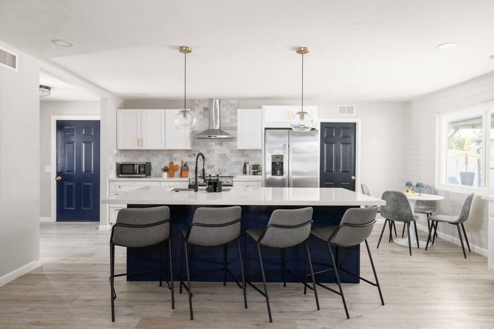 Bright, modern kitchen opens to the dining and living areas. Fully equipped with everything a chef needs to cook, gather, and enjoy.