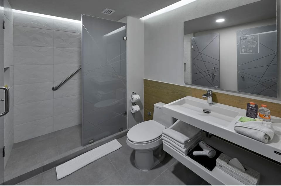 Rejuvenate with fluffy towels and a bright, modern vanity.