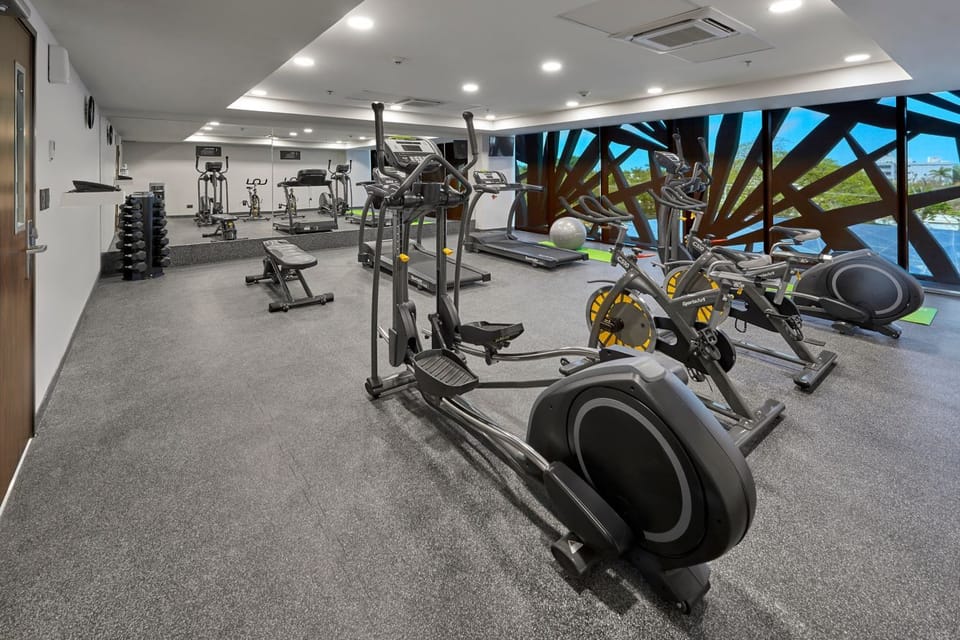 Power through workouts beside expansive windows and modern cardio.