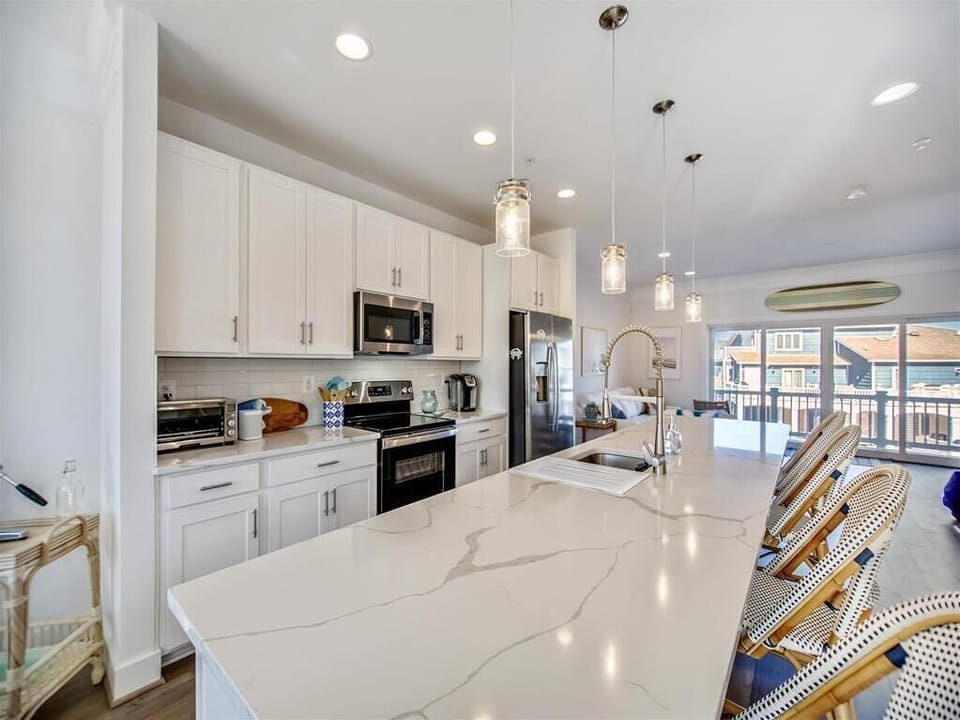 Relax in a spacious living area that seamlessly connects to your outdoor patio, offering picturesque views and a perfect setting for leisurely evenings.