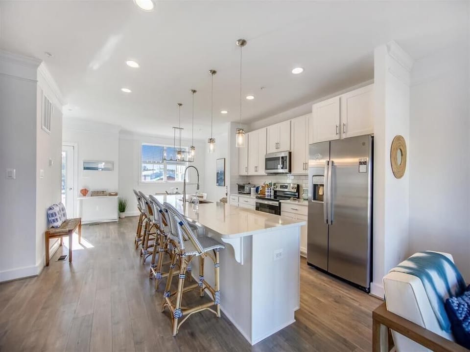 Cook and entertain effortlessly in the bright, modern kitchen equipped with stainless steel appliances and ample counter space.