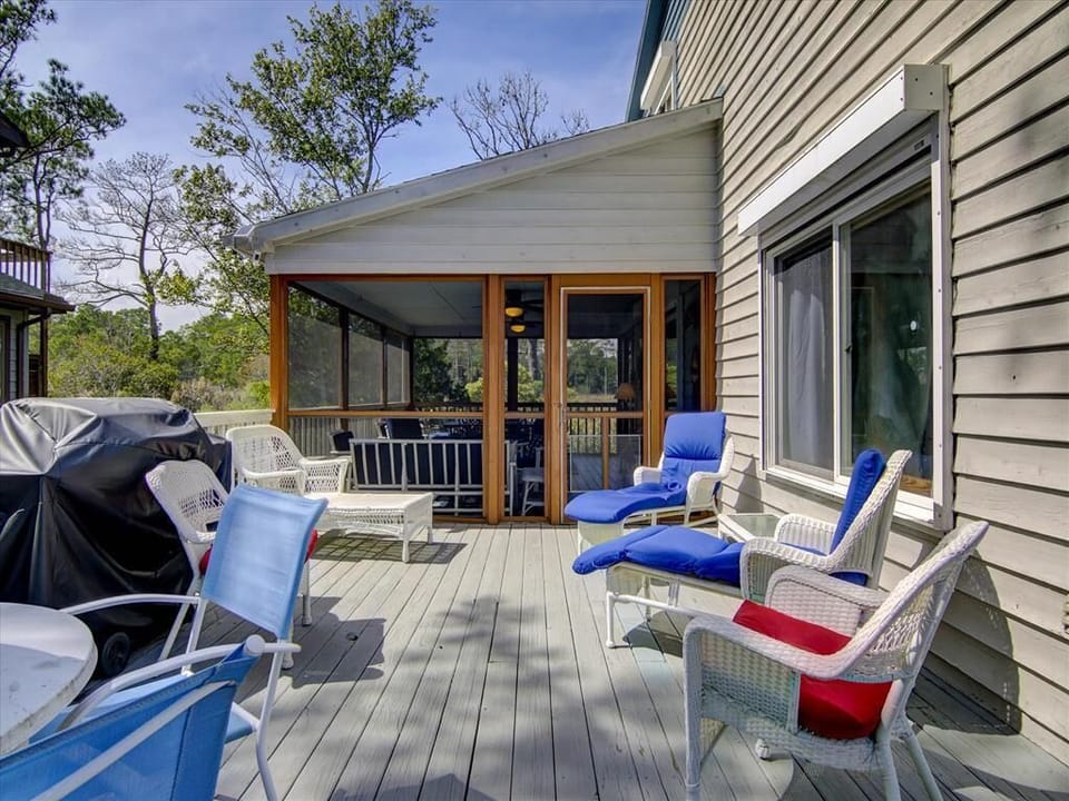 The expansive deck, equipped with outdoor seating and a BBQ, creates the perfect setting for al fresco dining and lounging.
