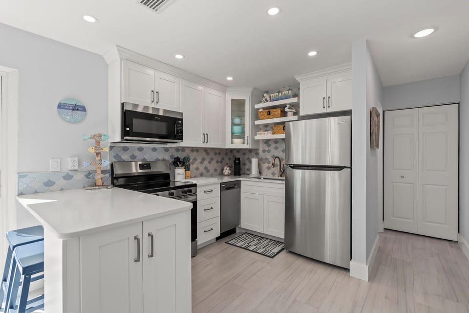 Fully stocked kitchen with pots/pans, spices, coffee maker & keurig, and more.