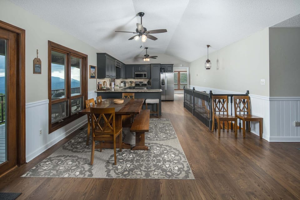 Open dining area and fully equipped kitchen with scenic mountain views throughout