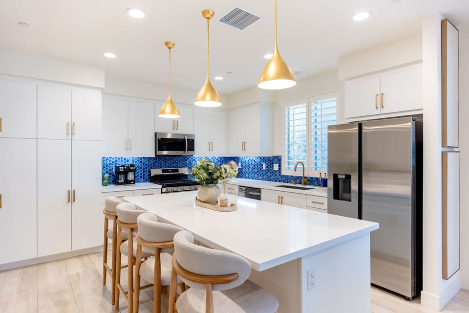Four bar stools at the kitchen island make it easy to grab a quick bite or coffee.