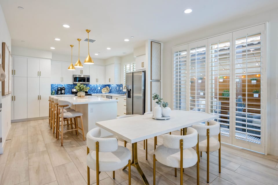 The dining table with the kitchen and living room all connected.