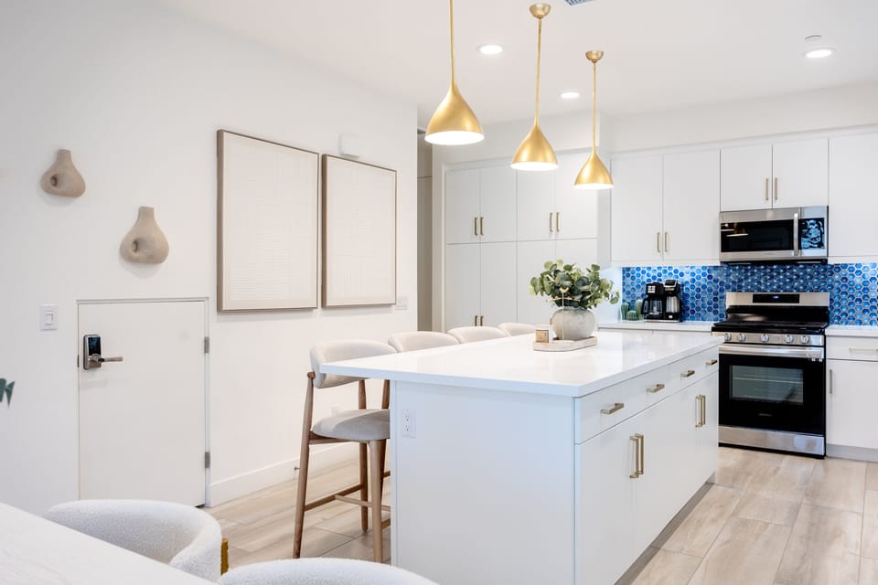 White cabinets, stainless appliances, and everything you need to cook.