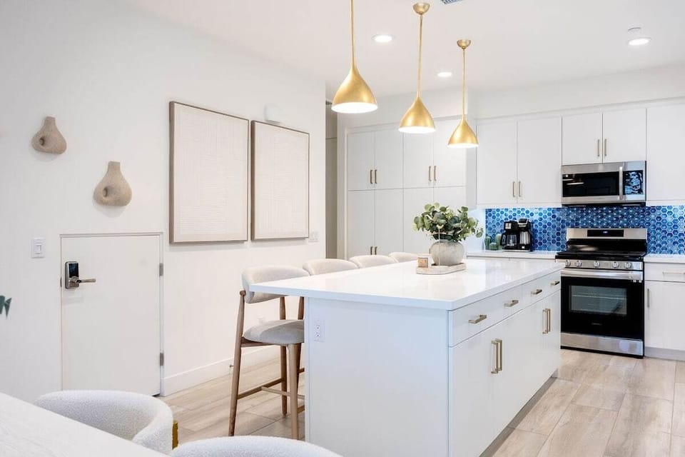 White cabinets, stainless appliances, and everything you need to cook.
