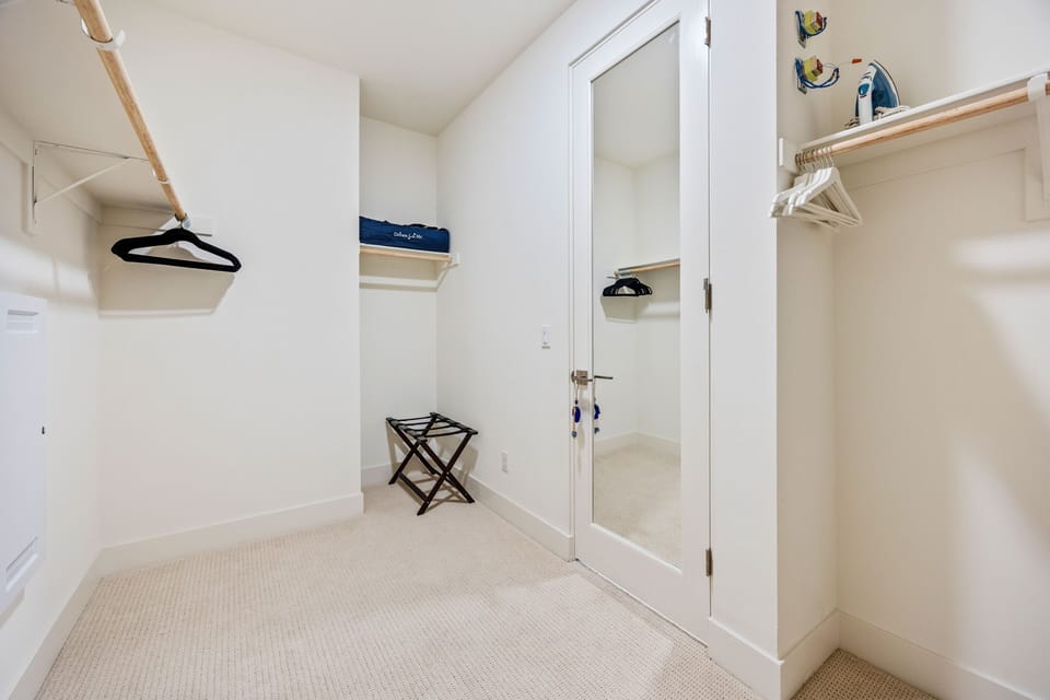 A spacious walk-in closet with built-in shelving for all your vacation wardrobe needs.