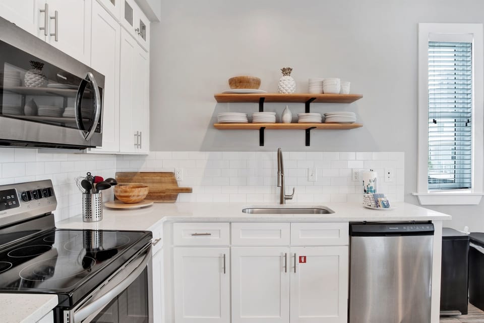 Coastal charm meets everyday function the bright kitchen features a clean, spacious sink and everything you need to feel right at home.