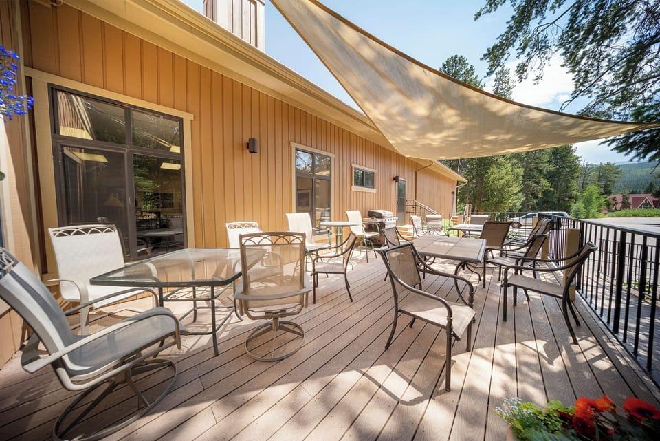 Relax on the clubhouse spacious deck with comfortable seating and shade sail overhead, perfect for outdoor dining and lounging.