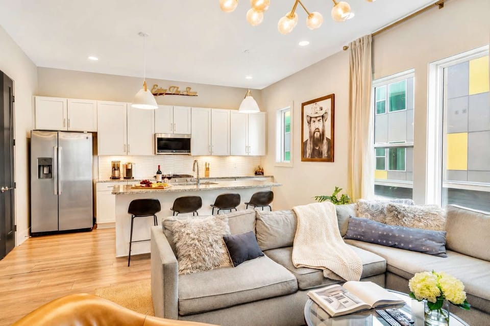A gray sectional and open kitchen keep the group connected while you're hanging before heading out to Shelby Park or catching a show