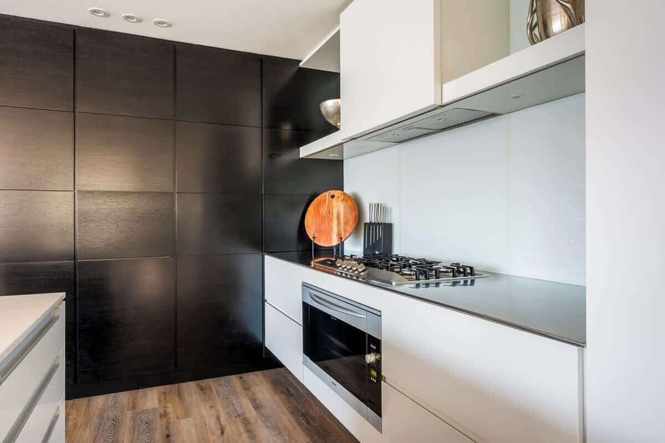 Bright and fully equipped, the kitchen invites you to cook with ease while enjoying lake and mountain views. A spacious pantry keeps all your essentials organized and accessible.